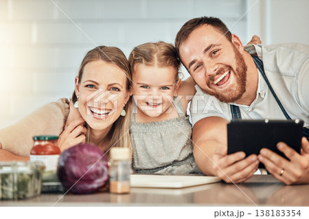 Happy family, cooking and parents with child in a kitchen to prepare a meal with online recipe in a home together. Bonding, smile and portrait of kid hug mother and father in a house with food Happy family, cooking and parents with child in a kitchen to prepare a meal with online recipe in a home together. Bonding, smile and portrait of kid hug mother and father in a house with food 138183354