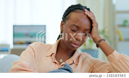 Sad, worry and black woman on couch with a problem, crisis and ideas of stress in a home living room or lounge. Fear, house and person scared and anxious about a mistake, fail or unhappy on a sofa Sad, worry and black woman on couch with a problem, crisis and ideas of stress in a home living room or lounge. Fear, house and person scared and anxious about a mistake, fail or unhappy on a sofa 138183563
