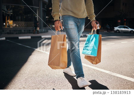 Man, legs and shopping bags in street of city, pedestrian or crosswalk for travel, shop or mall. Male person or shopper walking on road with paper bag for discount, sale or retail store in urban town Man, legs and shopping bags in street of city, pedestrian or crosswalk for travel, shop or mall. Male person or shopper walking on road with paper bag for discount, sale or retail store in urban town 138183913