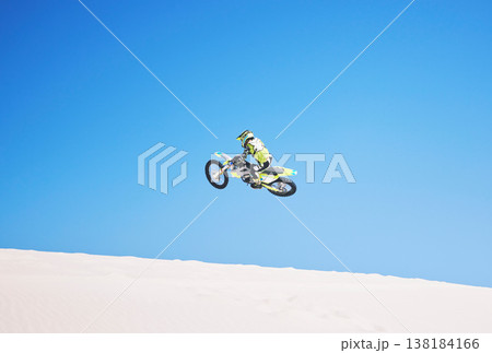 Motorbike, jump and man in the air with blue sky, mock up and stunt in sports with fearless person in danger with freedom. Motorcycle, jumping and athlete training for challenge or competition 138184166