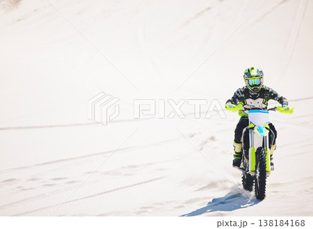 Man, driving and motorbike on sand for sport, adventure or competition outdoor in summer or mockup space. Motorcycle, ride and athlete on dirt, dune or desert for race, danger and fearless challenge 138184168