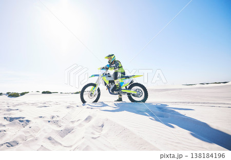 Desert, motorbike and man outdoor for sport, adventure and travel on mockup space. Offroad, sand and driver on motorcycle on dirt track in nature for action, competition race and thinking of freedom 138184196
