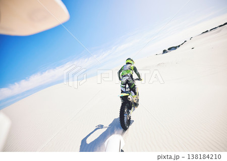 Desert, back and man on motorcycle for sport, adventure and travel for extreme challenge outdoor. Off road, sand and driver riding motorbike on dirt in nature for action, competition race or freedom Desert, back and man on motorcycle for sport, adventure and travel for extreme challenge outdoor. Off road, sand and driver riding motorbike on dirt in nature for action, competition race or freedom 138184210