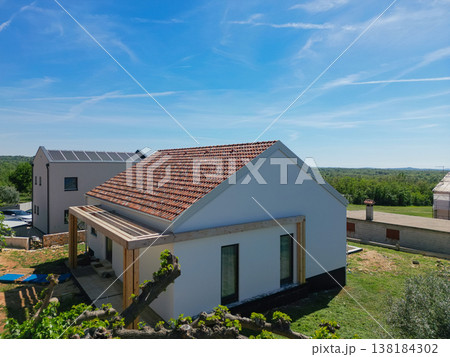 Modular modern smart house with red tiled roof and unfinished outdoor pergola in aerial view Modular modern smart house with red tiled roof and unfinished outdoor pergola in aerial view 138184302