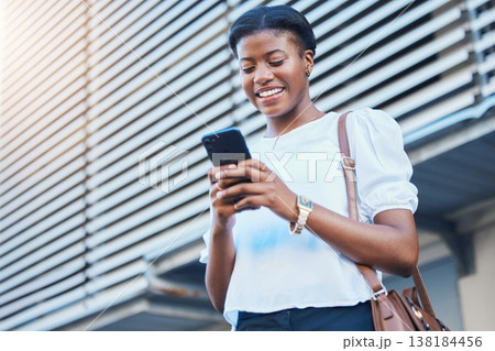 Cellphone, walking and young woman in the city networking on social media, mobile app or the internet. Happy, technology and African female person scroll on a phone and commuting in urban town street Cellphone, walking and young woman in the city networking on social media, mobile app or the internet. Happy, technology and African female person scroll on a phone and commuting in urban town street 138184456