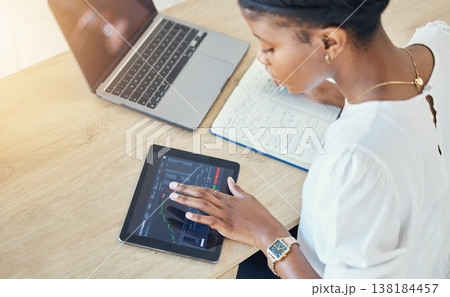 Tablet, cryptocurrency and black woman trading in office, finance analysis or writing in book for planning investment. Tech, stock market or business professional typing on chart, graph or statistics 138184457