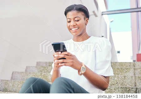 Phone, stairs and young woman in a building networking on social media, mobile app or the internet. Smile, technology and African female person scroll on website with cellphone in a modern office. Phone, stairs and young woman in a building networking on social media, mobile app or the internet. Smile, technology and African female person scroll on website with cellphone in a modern office. 138184458