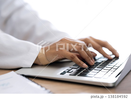 Closeup, hands and doctor with a laptop, typing and connection with research, network and website info. Person, medical professional and worker with plaster, pc and keyboard with deadline and app Closeup, hands and doctor with a laptop, typing and connection with research, network and website info. Person, medical professional and worker with plaster, pc and keyboard with deadline and app 138184592