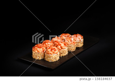 Delicious Fresh Salmon Sushi Rolls Presenting Exquisitely on a Black Background Delicious Fresh Salmon Sushi Rolls Presenting Exquisitely on a Black Background 138184637