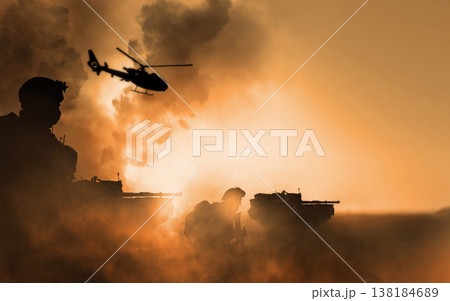 War, explosion and helicopter, soldier silhouette on battlefield with conflict, military vehicle and politics. Orange, fire and smoke from fight, people in armed forces and warzone with army warrior 138184689