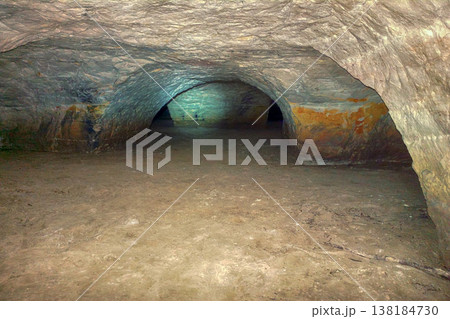 dark cave walk under ground in tunnel dark cave walk under ground in tunnel 138184730