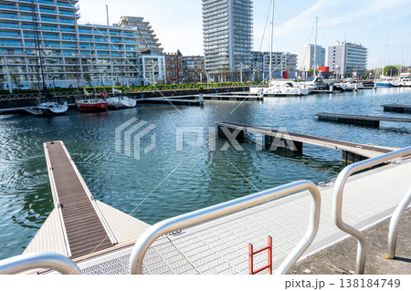 Beautiful city with port, yachts, ships, sea water, modern buildings. Water transport in the harbor. Belgium, Ostend. Beautiful city with port, yachts, ships, sea water, modern buildings. Water transport in the harbor. Belgium, Ostend. 138184749