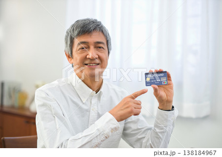 リビングでカードを見る60代の男性 リビングでカードを見る60代の男性 138184967