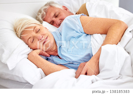 Sleeping, bedroom and senior couple with love, relax and retirement on a weekend break, resting and calm. Peace, old woman or elderly man in a bed, home or morning with care, marriage or relationship 138185383