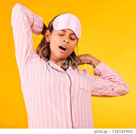 Woman, pajamas and yawn with stretch in studio for sleep or peaceful for stress, tired or sad for burnout. Female model, eye mask and relax for dream or wake up for insomnia, headache or self care Woman, pajamas and yawn with stretch in studio for sleep or peaceful for stress, tired or sad for burnout. Female model, eye mask and relax for dream or wake up for insomnia, headache or self care 138185403