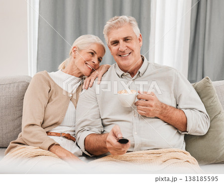 Old couple, home and watching tv with coffee and happiness together in retirement, partner and remote control. Love, care and online streaming, tv show with tea and people relax on couch for movie Old couple, home and watching tv with coffee and happiness together in retirement, partner and remote control. Love, care and online streaming, tv show with tea and people relax on couch for movie 138185595