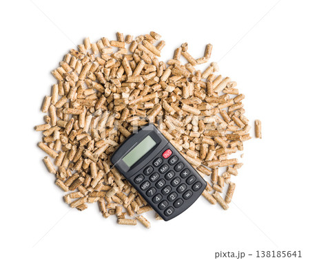 Calculator on Pile of Wood Pellets Representing Biofuel Cost, Renewable Energy Accounting and Fuel Efficiency Analysis Calculator on Pile of Wood Pellets Representing Biofuel Cost, Renewable Energy Accounting and Fuel Efficiency Analysis 138185641
