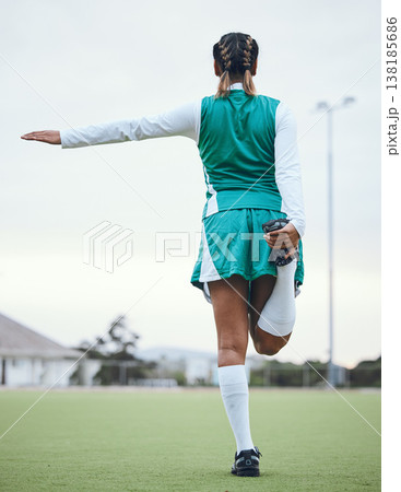 Back, sports and a woman hockey player stretching for the start of a game or competition outdoor. Balance, fitness and warm up with the legs of an athlete getting ready for training on a field Back, sports and a woman hockey player stretching for the start of a game or competition outdoor. Balance, fitness and warm up with the legs of an athlete getting ready for training on a field 138185686