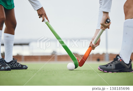 Fitness, hockey and women with sticks and ball on field for training, competition or challenge outdoor. Sports, person and legs on grass with workout, battle or exercise for wellness in nature Fitness, hockey and women with sticks and ball on field for training, competition or challenge outdoor. Sports, person and legs on grass with workout, battle or exercise for wellness in nature 138185696