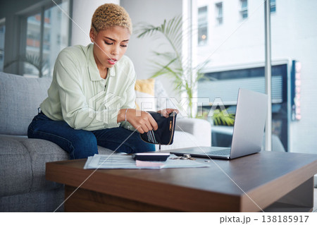 Home, finance and woman with a laptop, stress and calculator with budget planning, review finances and inflation. Person, paperwork and girl on a sofa, pc or counting with wallet and bankruptcy 138185917