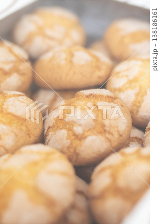 Homemade style cookies on metal tray highlight crackled surface and inviting bakery atmosphere Homemade style cookies on metal tray highlight crackled surface and inviting bakery atmosphere 138186161