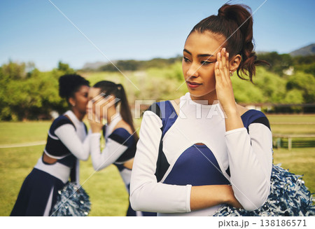 Bullying, cheerleader or friends with gossip about woman, talking behind back and secret on field. School, sports or students speaking of a sad girl teenager with rumor, problem or conversation 138186571