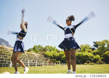 Dance, cheerleading and women on a field for training, teamwork and a performance for a game. Cheerleader, happy and a team with a routine, sports or motivation for an event on school grass together Dance, cheerleading and women on a field for training, teamwork and a performance for a game. Cheerleader, happy and a team with a routine, sports or motivation for an event on school grass together 138186626