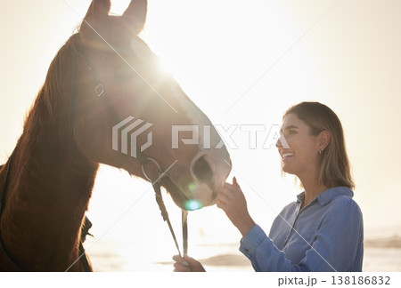 Woman, smile and horse in nature with lens flare for bonding and relax on farm, ranch or countryside. Animal, face and person feeling stallion for freedom, adventure or vacation in summer with care Woman, smile and horse in nature with lens flare for bonding and relax on farm, ranch or countryside. Animal, face and person feeling stallion for freedom, adventure or vacation in summer with care 138186832