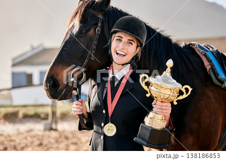 Portrait, equestrian and prize horse with a woman on a ranch for sports, training or a leisure hobby. Winner, trophy or award and a happy young rider in uniform with her stallion or mare outdoor 138186853