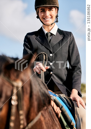 Portrait, equestrian and a woman jockey with her horse on a ranch for sports, training or a leisure hobby. Smile, riding or competition and a happy young rider in uniform with her stallion outdoor Portrait, equestrian and a woman jockey with her horse on a ranch for sports, training or a leisure hobby. Smile, riding or competition and a happy young rider in uniform with her stallion outdoor 138186862