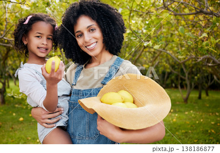 Woman with child, lemon orchard and nature, agriculture with healthy food and nutrition, portrait on citrus farm outdoor. Farmer, mother and daughter time picking fruit and smile, harvest and bonding 138186877