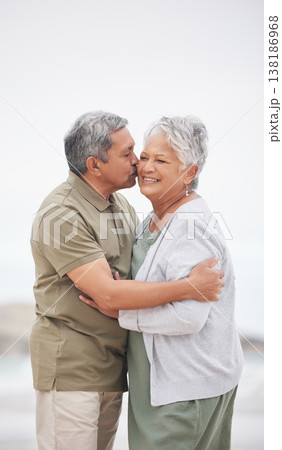 Senior couple, kiss or hug on beach with smile, embrace and enjoying for retirement, happy or love. Senior citizen, romance and lovers with bond, happiness and vacation for travel, anniversary or fun Senior couple, kiss or hug on beach with smile, embrace and enjoying for retirement, happy or love. Senior citizen, romance and lovers with bond, happiness and vacation for travel, anniversary or fun 138186968
