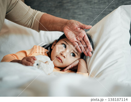 Girl kid, check for fever and sick in bed with hand on head, health and wellness, parent monitor temperature at home. Headache, illness and young child with the flu, medical help and support of mom 138187114