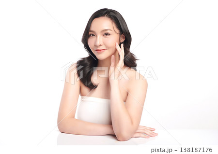 A beautiful young Asian woman with clean, fresh skin against a white background. Skincare, facial treatment, cosmetology, beauty, and spa. An elegant portrait of an Asian woman. 138187176