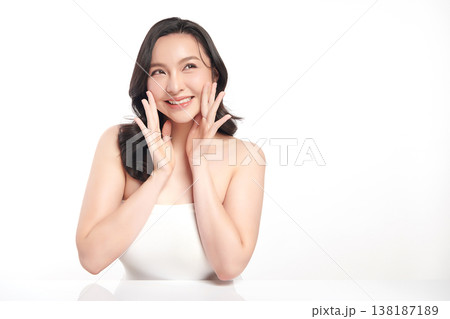A beautiful young Asian woman with clean, fresh skin against a white background. Skincare, facial treatment, cosmetology, beauty, and spa. An elegant portrait of an Asian woman. 138187189