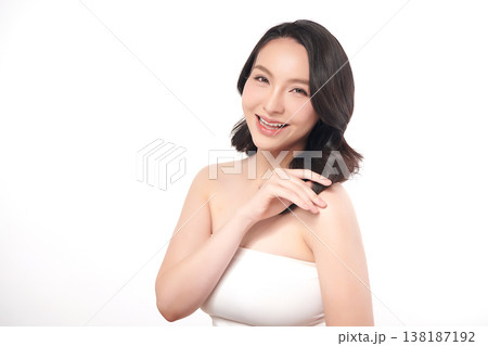 A beautiful young Asian woman with clean, fresh skin against a white background. Skincare, facial treatment, cosmetology, beauty, and spa. An elegant portrait of an Asian woman. A beautiful young Asian woman with clean, fresh skin against a white background. Skincare, facial treatment, cosmetology, beauty, and spa. An elegant portrait of an Asian woman. 138187192
