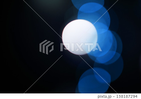Bokeh, blue particles and neon on black background with pattern, texture and mockup with cosmic aesthetic. Night lighting, sparkle lights and glow on dark wallpaper with space, color shine and flare. 138187294