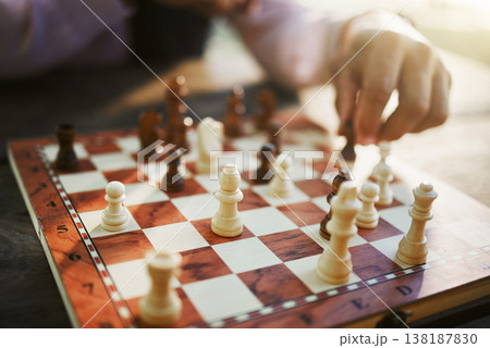 Hands, chess game and board with strategy in competition or challenge, intelligence and closeup of people playing. Thinking, planning and contest outdoor, concentration on boardgame and recreation 138187830
