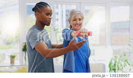 Elderly woman, dumbbells and rehabilitation therapist for exercise in a nursing home. Happy senior patient with physiotherapist man or nurse for healing, health and physiotherapy for muscle and body Elderly woman, dumbbells and rehabilitation therapist for exercise in a nursing home. Happy senior patient with physiotherapist man or nurse for healing, health and physiotherapy for muscle and body 138188007