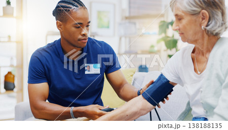 Caregiver, black man or old woman with blood pressure test consulting in hospital to monitor heart wellness. Healthcare, hypertension consultation or medical nurse with sick patient for examination Caregiver, black man or old woman with blood pressure test consulting in hospital to monitor heart wellness. Healthcare, hypertension consultation or medical nurse with sick patient for examination 138188135