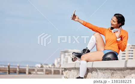 Roller skating, woman and selfie with smile for profile picture, internet post and social media outdoor in nature. Sport, person and headphones by ocean or sea for relax, freedom and happiness online 138188225