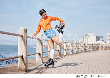 Roller skate, stretching and space with a girl at the promenade on a blue sky background for the weekend. Fitness, beach and balance with a young person skating outdoor during summer on banner mockup Roller skate, stretching and space with a girl at the promenade on a blue sky background for the weekend. Fitness, beach and balance with a young person skating outdoor during summer on banner mockup 138188239