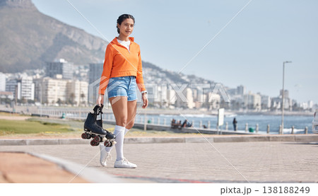 Woman, roller skates and promenade in city, portrait and outdoor for training, competition or fitness by ocean. Gen z girl, skating and walking for exercise, workout or metro road by sea in Cape Town Woman, roller skates and promenade in city, portrait and outdoor for training, competition or fitness by ocean. Gen z girl, skating and walking for exercise, workout or metro road by sea in Cape Town 138188249