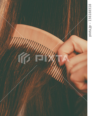 Happy woman brushing her hair Happy woman brushing her hair 138188318