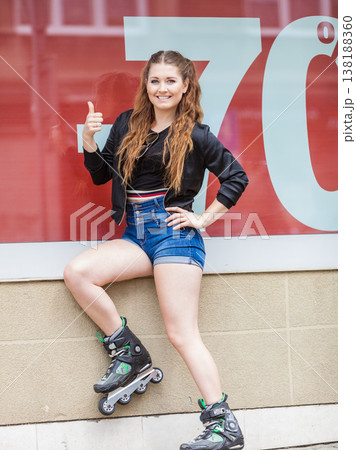 Woman wearing roller skates next to sale 138188360