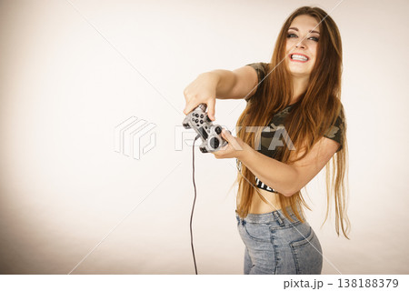 Gamer woman holding gaming pad 138188379