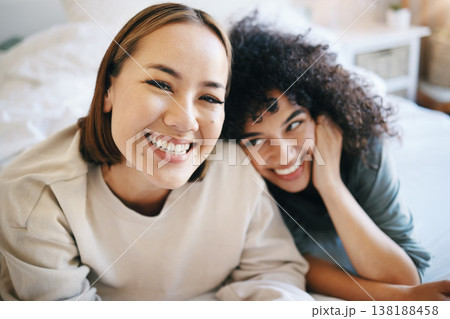 Love, happy and portrait of lesbian couple relaxing on bed for bonding together on a weekend. Smile, romance and young interracial lgbtq women resting in the bedroom of modern apartment or home. Love, happy and portrait of lesbian couple relaxing on bed for bonding together on a weekend. Smile, romance and young interracial lgbtq women resting in the bedroom of modern apartment or home. 138188458