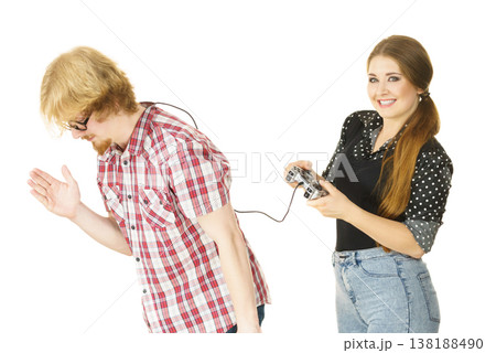 Woman controling man using gaming pad Woman controling man using gaming pad 138188490