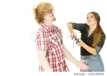 Woman controling man using gaming pad Woman controling man using gaming pad 138188492