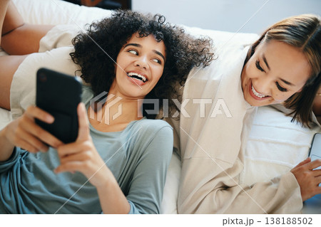 Home, lesbian couple and women with a phone, digital app and typing with social media, relax and romance. Communication, queer people and happy girls with a cellphone, mobile user and meme with post Home, lesbian couple and women with a phone, digital app and typing with social media, relax and romance. Communication, queer people and happy girls with a cellphone, mobile user and meme with post 138188502